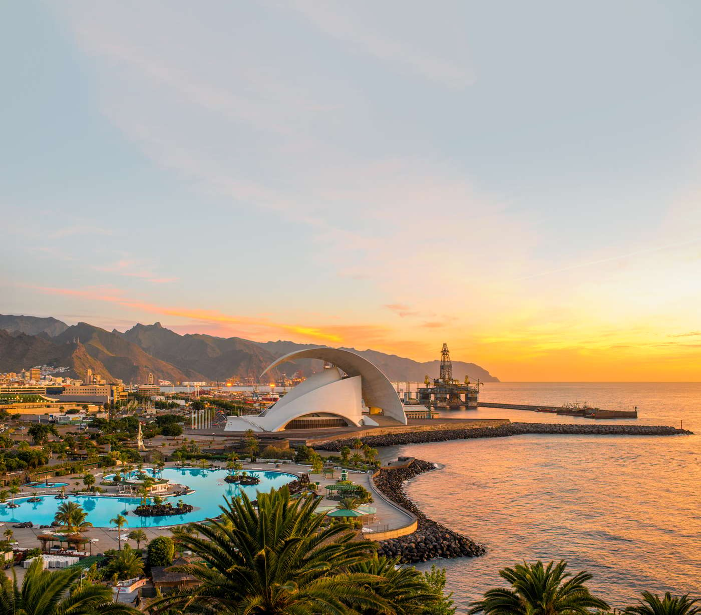 Santa Cruz cityscape view with park, ocean and mountains on the background on the sunrise, Canary islands, Spain