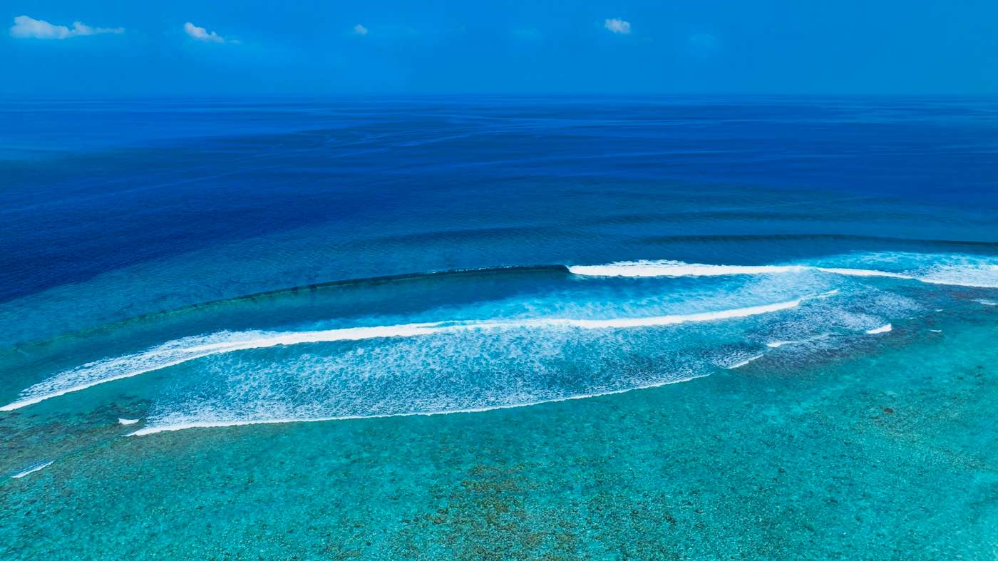 The soft wave water of the sea on the sandy beach background