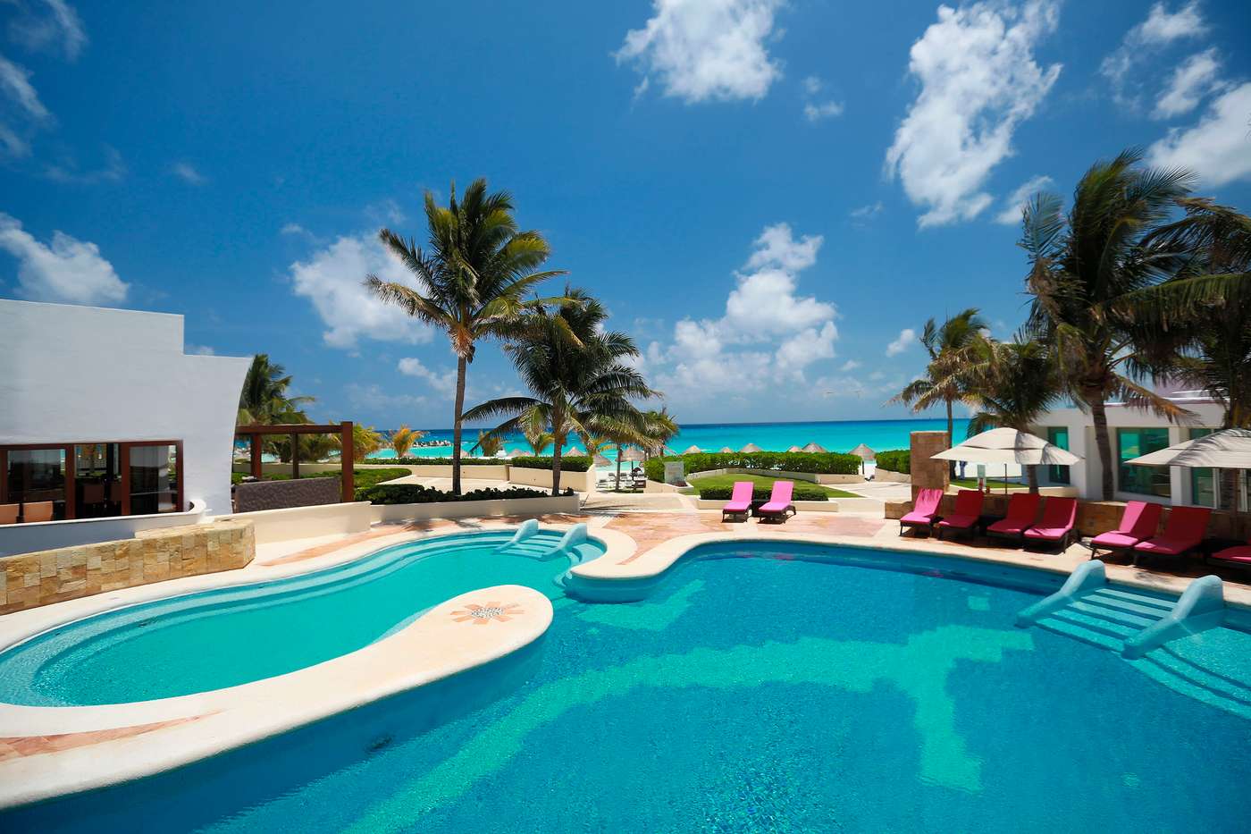 pool, sun beds and palm trees