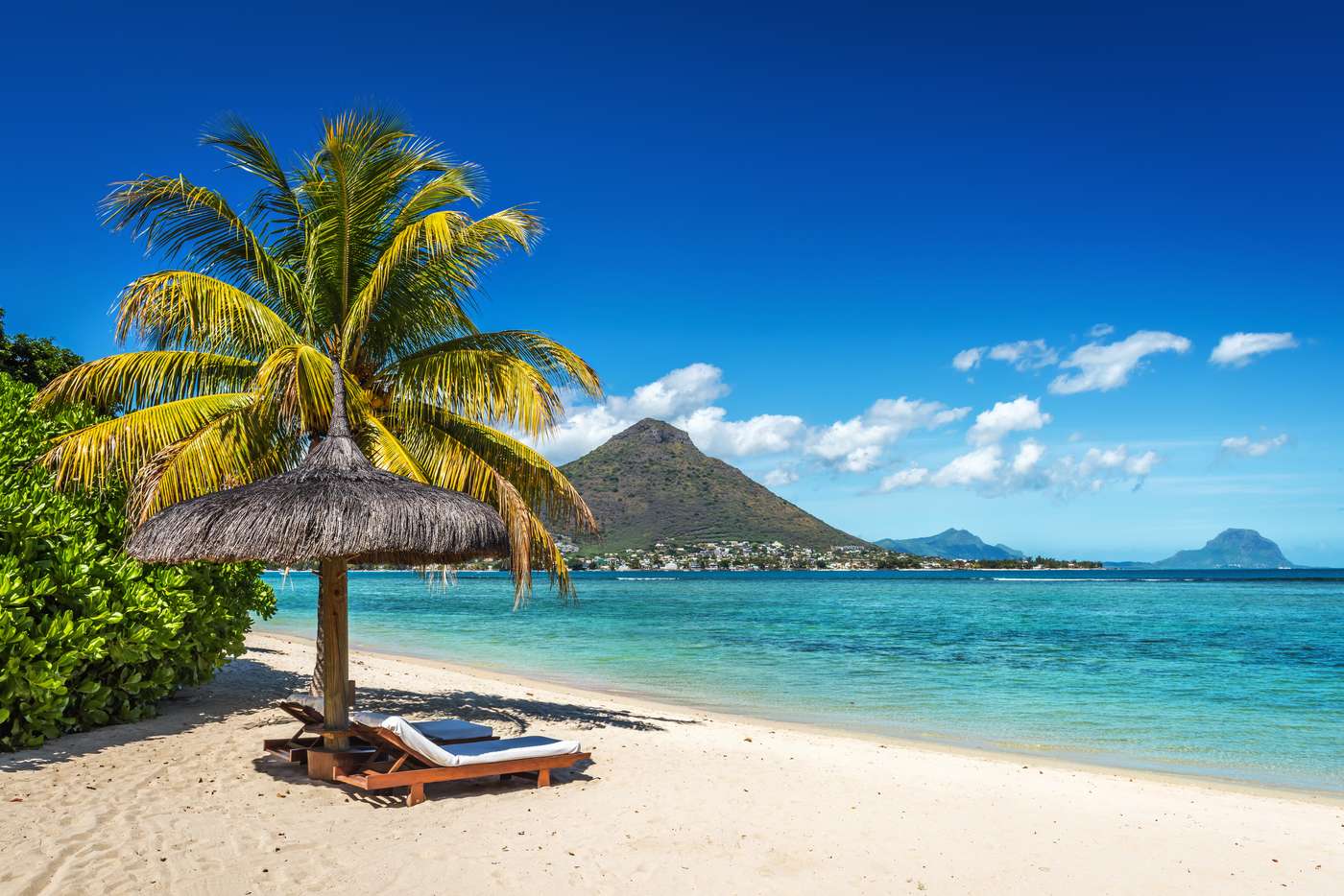 Loungers and umbrella on tropical beach in Mauritius Island, Indian Ocean