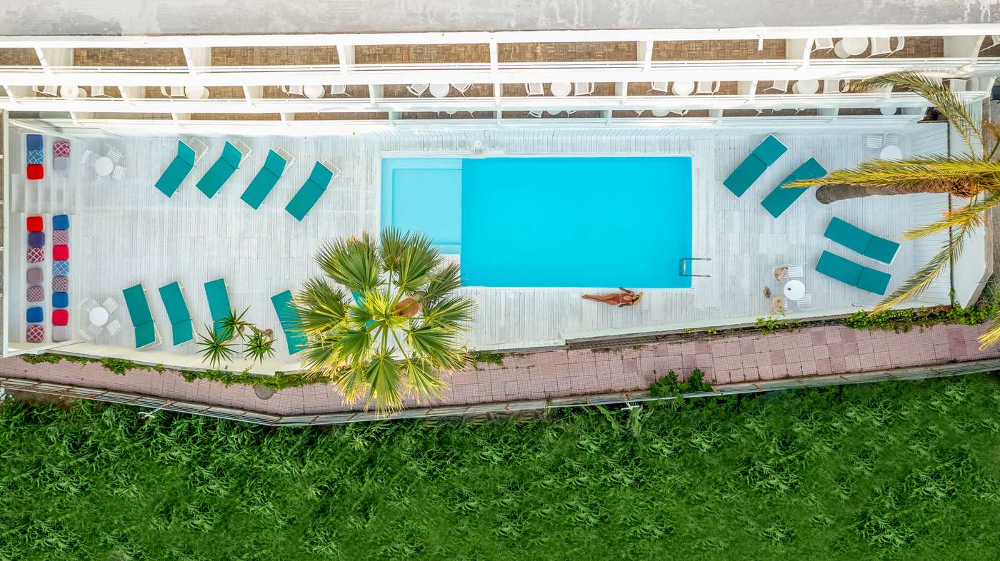 Rectangular pool from above with surrounding sun loungers