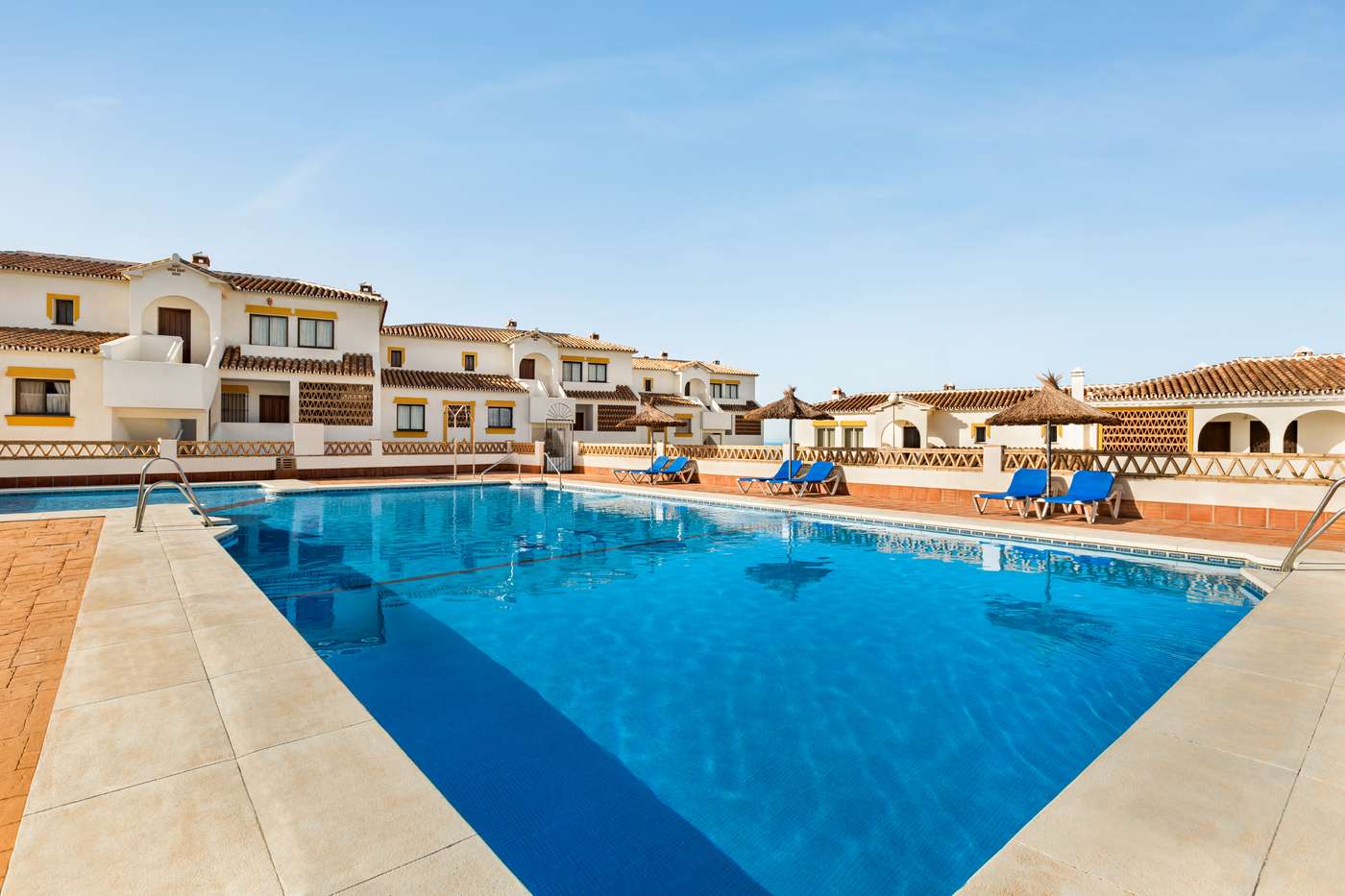 Outdoor pool area with sunbeds.