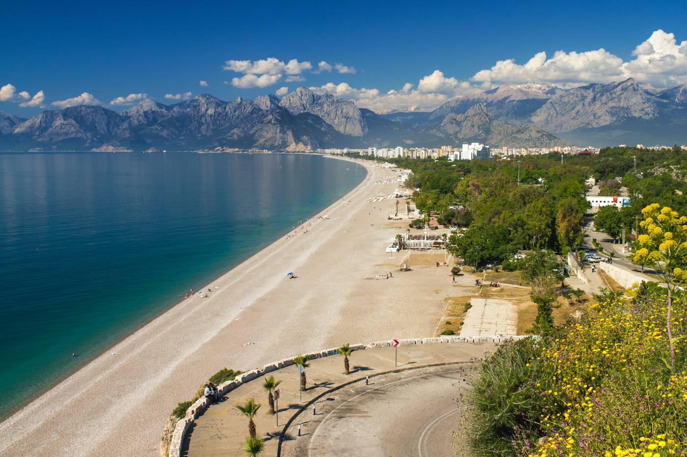 Beach in Antalya with mountains in the background.