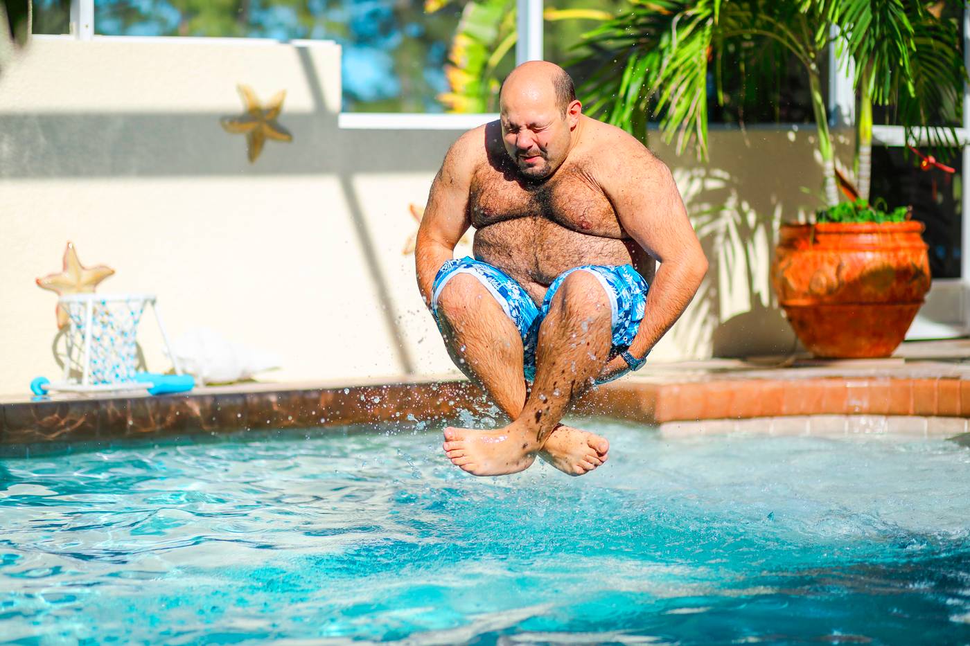 Man jumping into the pool