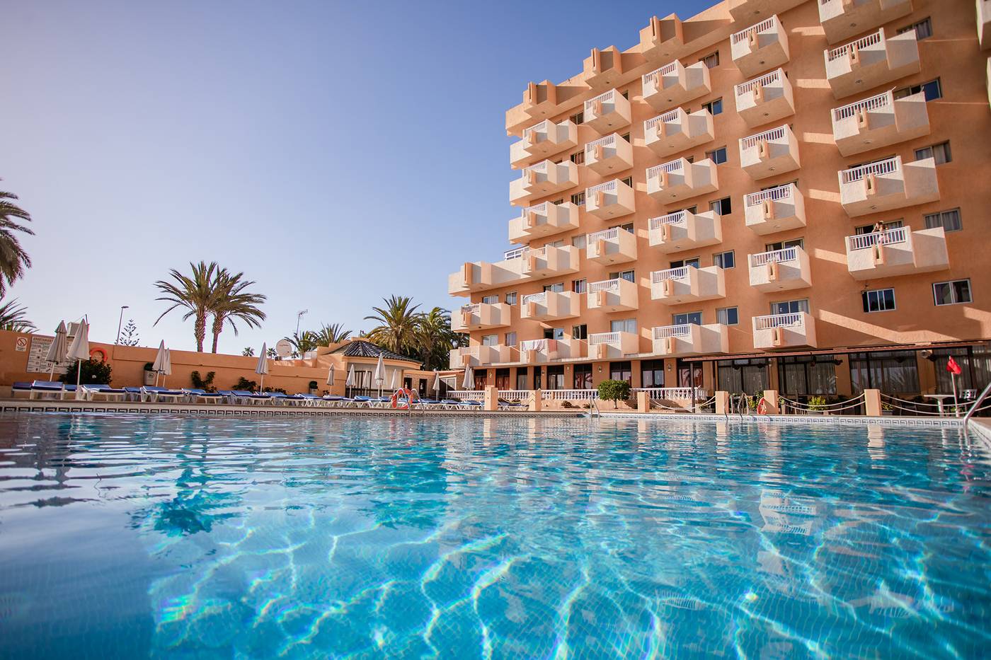 Outdoor pool, with hotel in the background.