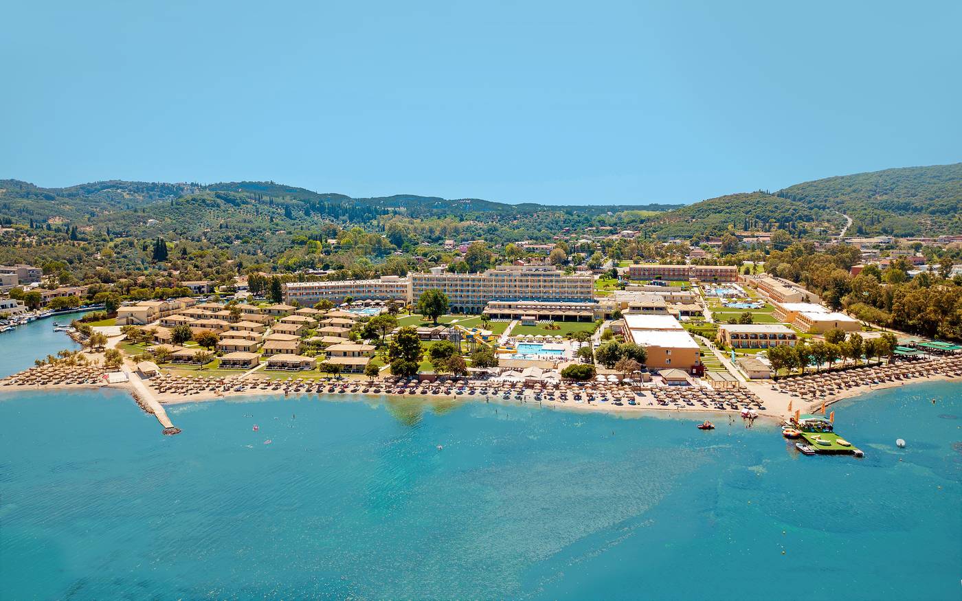 Exterior wide shot of hotel resort with sea and surrounding landscapes