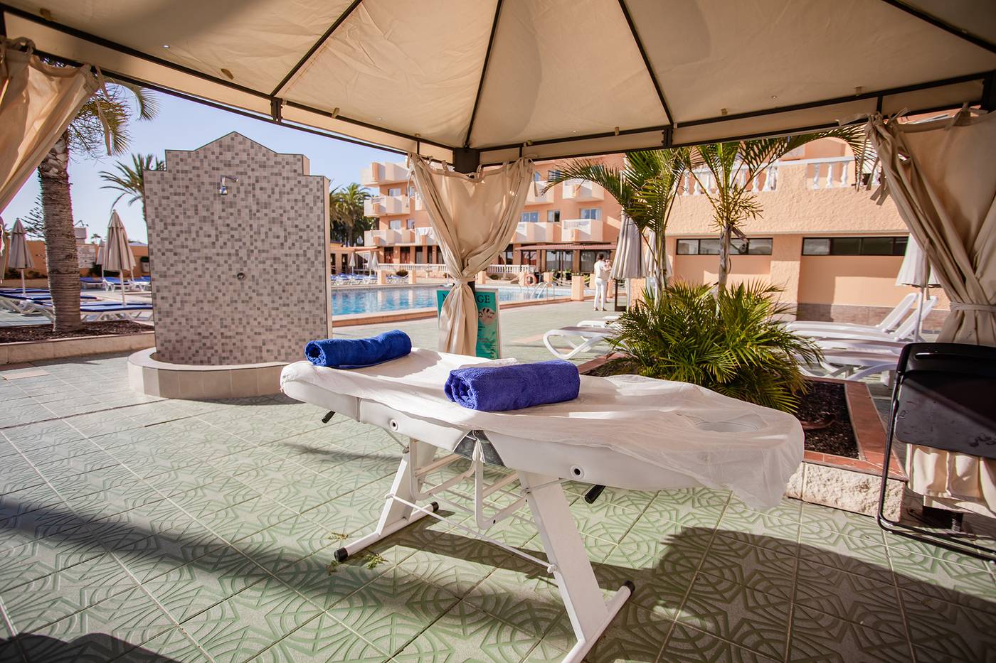 Massage bed in covered outdoor area.