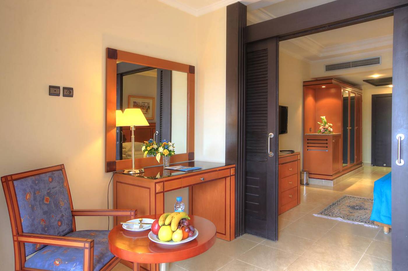 Seating area and mirror in a hotel room at the Aqua Fun Club. 